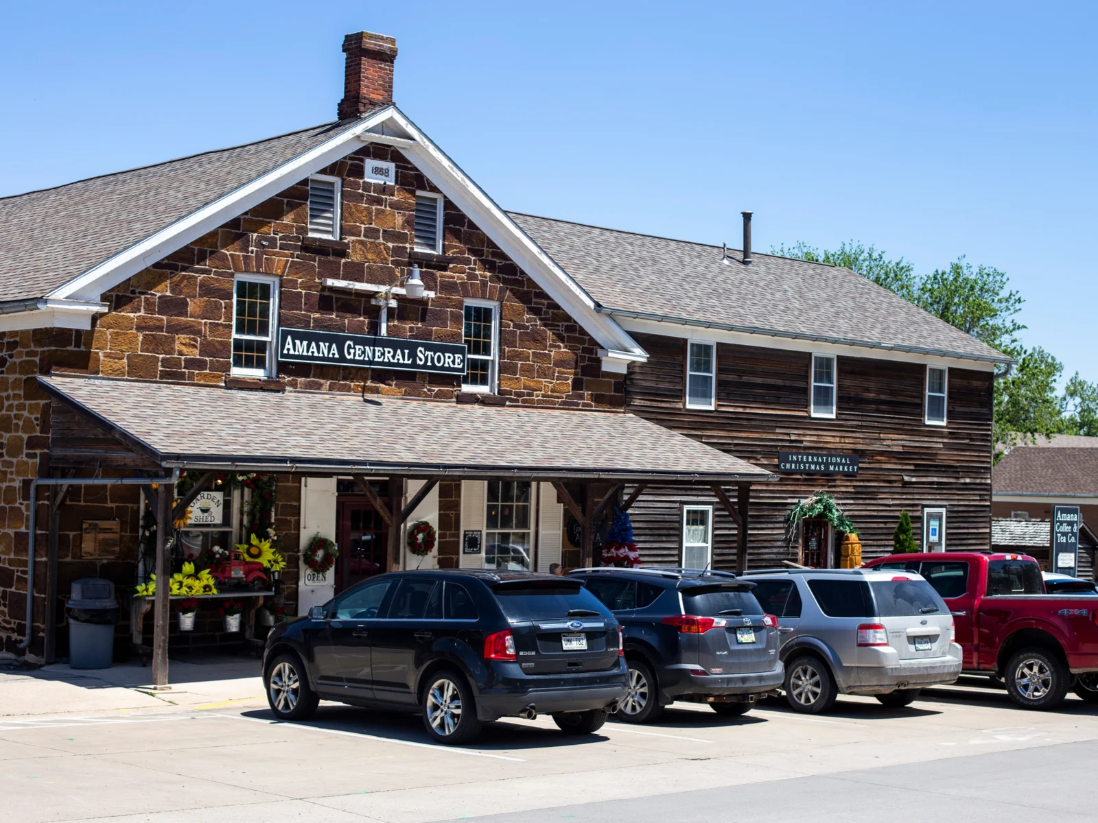 A pick for what to see in Iowa, the classic Amana General Store at the Amana Colonies with cars parked in front
