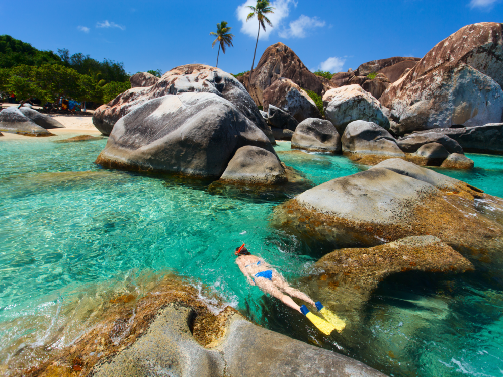 Woman snorkeling in a giant rock formation on Virgin Gorda, one of the best places to visit in the Caribbean