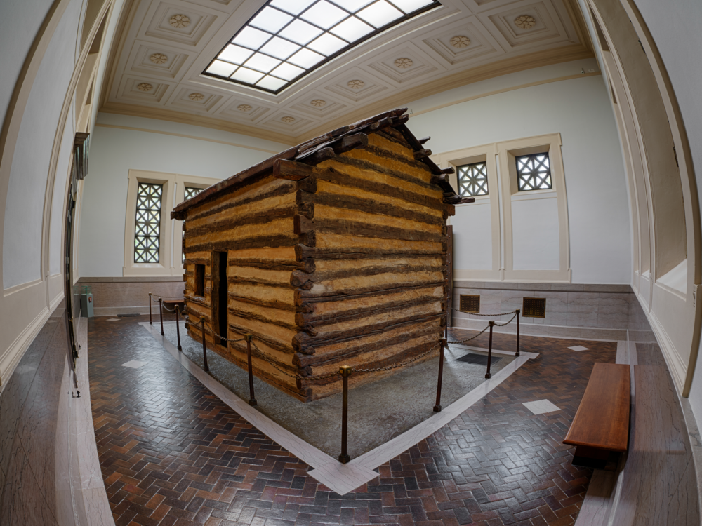 Fish-eye view of the of log cabin where the late Abraham Lincoln was born, one of the best things to do in Kentucky, exhibited inside Abraham Lincoln Birthplace National Historic Park