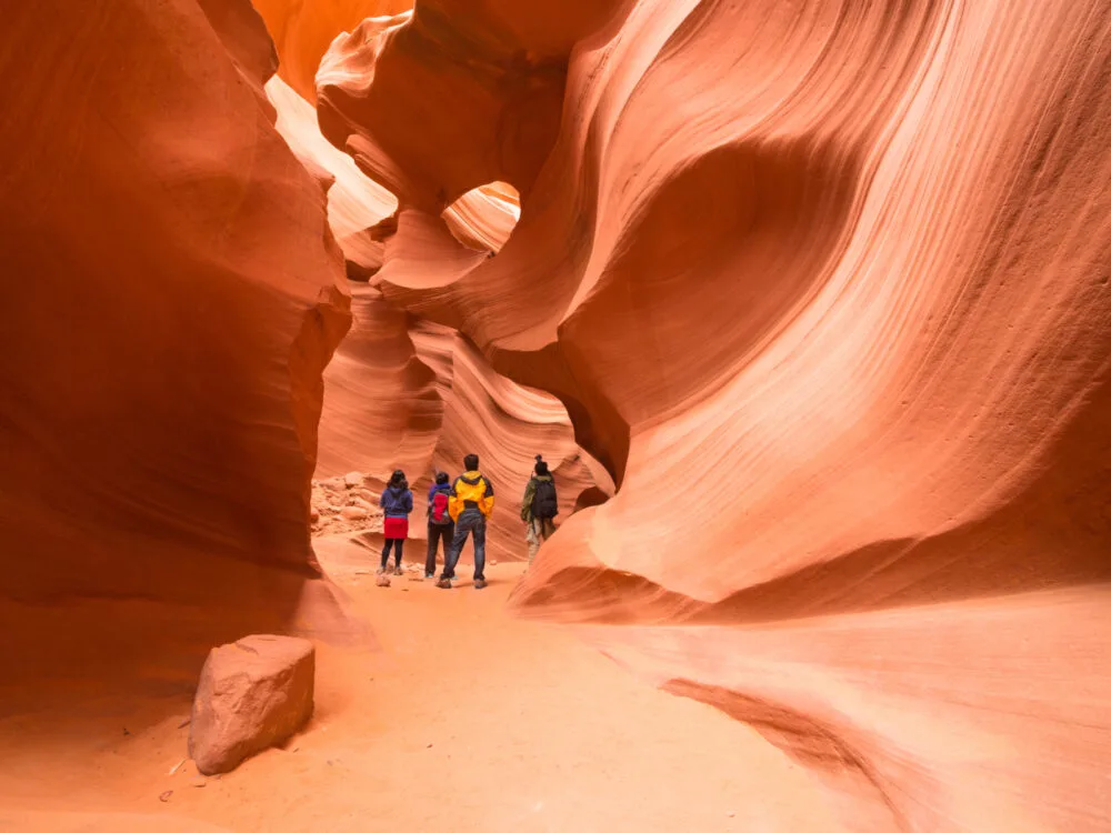 Four people walking through Antelope Canyon for a piece on the best places to visit in Arizona