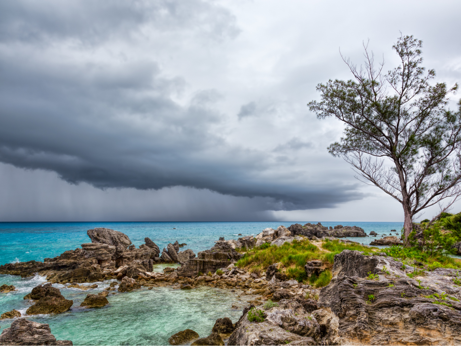 Severe rain storm over Tobacco Bay Beach during the worst time to visit Bermuda