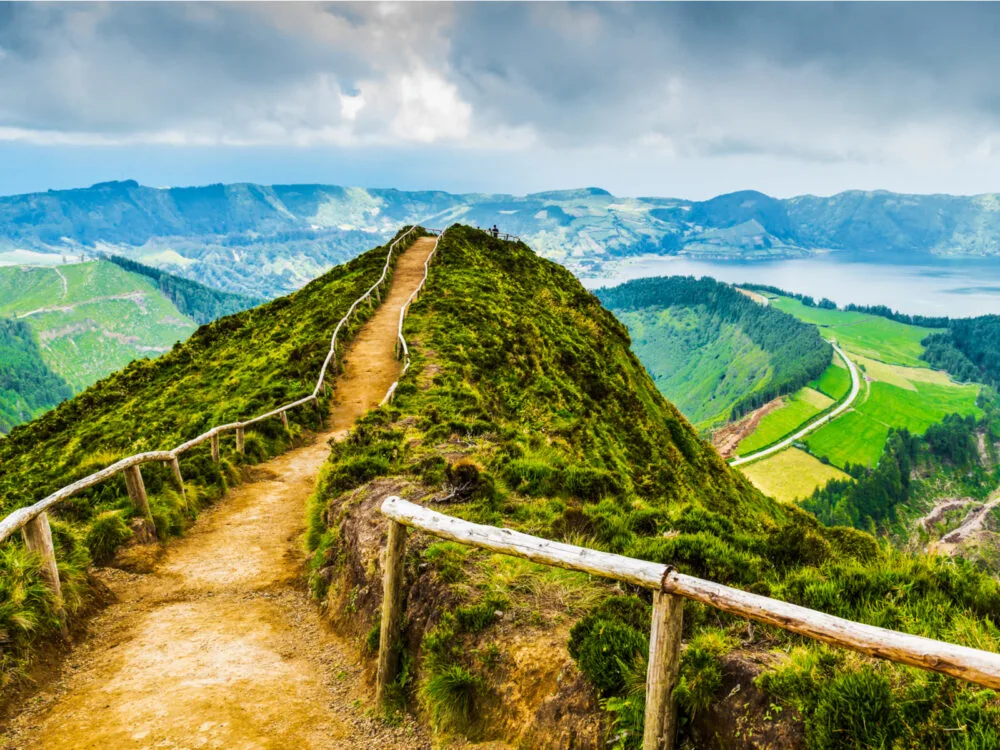 Walking path over a giant hilly landscape in the Azores, one of the best places to visit in Portugal