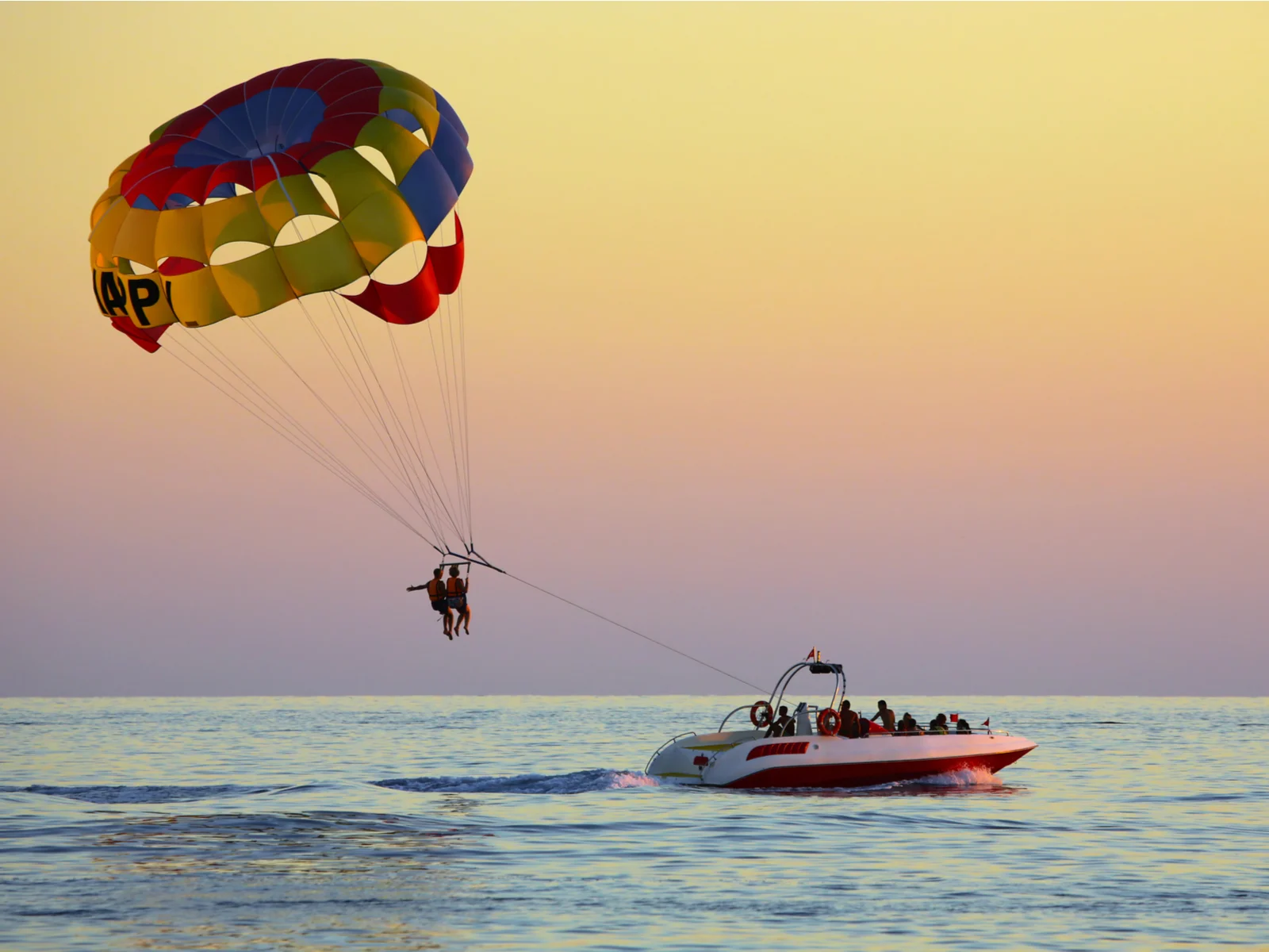 People going parasailing at dusk, one of the best things to do in Myrtle Beach