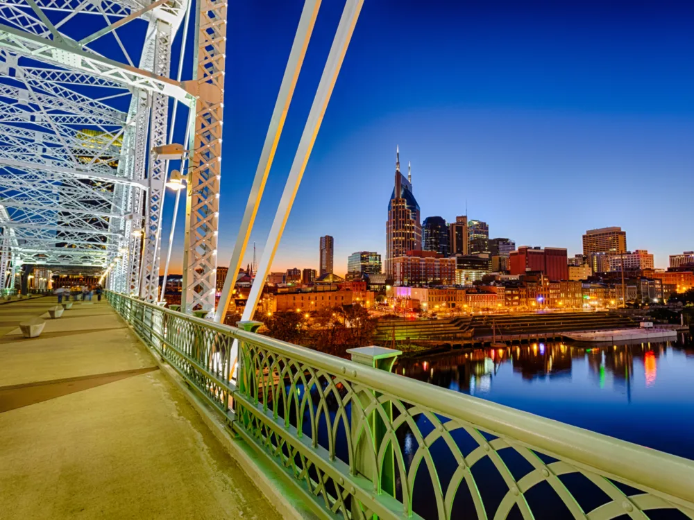 View of the Nashville skyline, full of the best hotels in Nashville, from a bridge at night