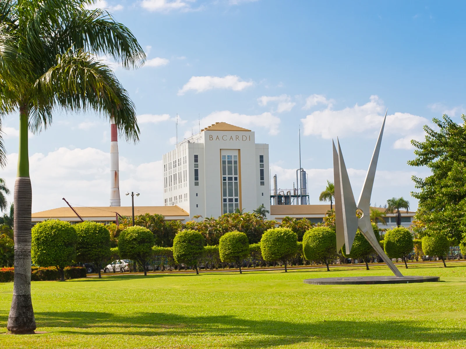 Casa Bacardi distillery with a neat landscape and a sculpture pictured as one of the best things to do in Puerto Rico