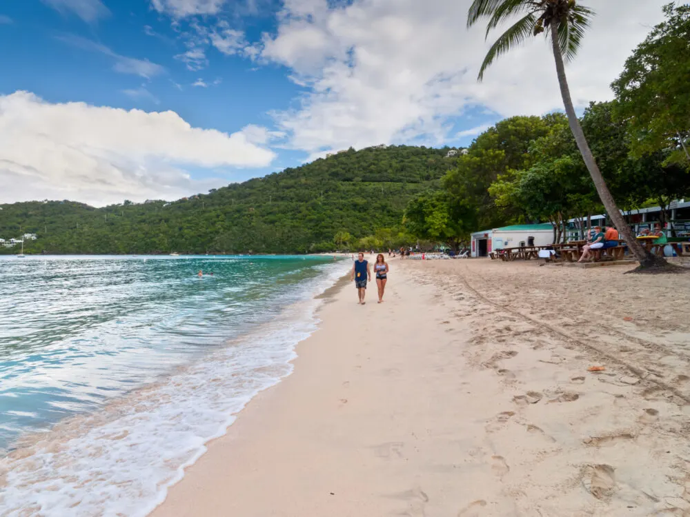 Middle aged couple walking on Magens Bay, the location of the very best resorts in St Thomas
