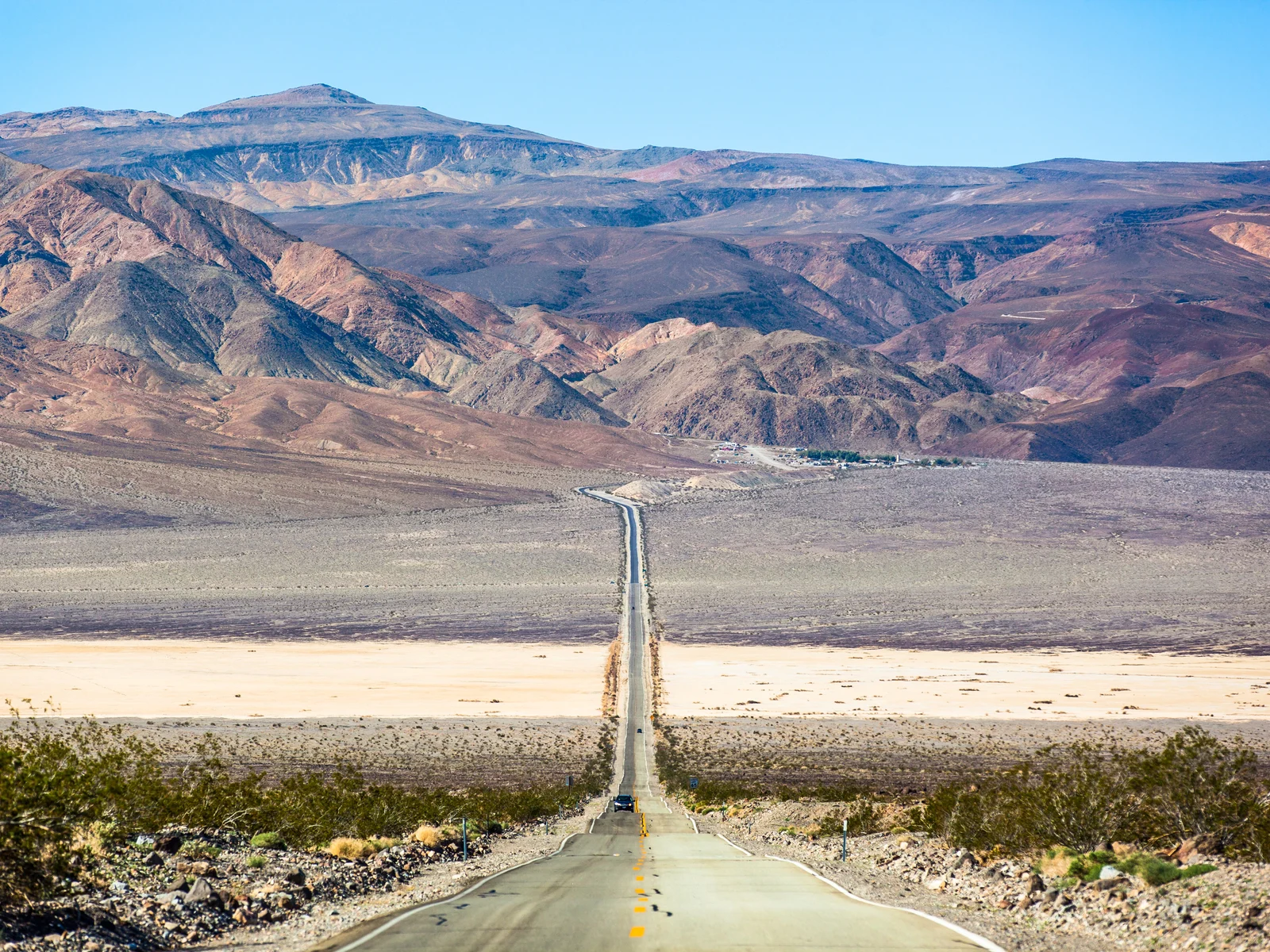 Image of Highway 190 crossing Panamint Valley during the cheapest time to visit Death Valley National Park, the Summer