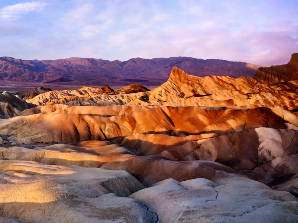 Gorgeous view of the sun setting on rock formations during the best time to visit Death Valley National Park