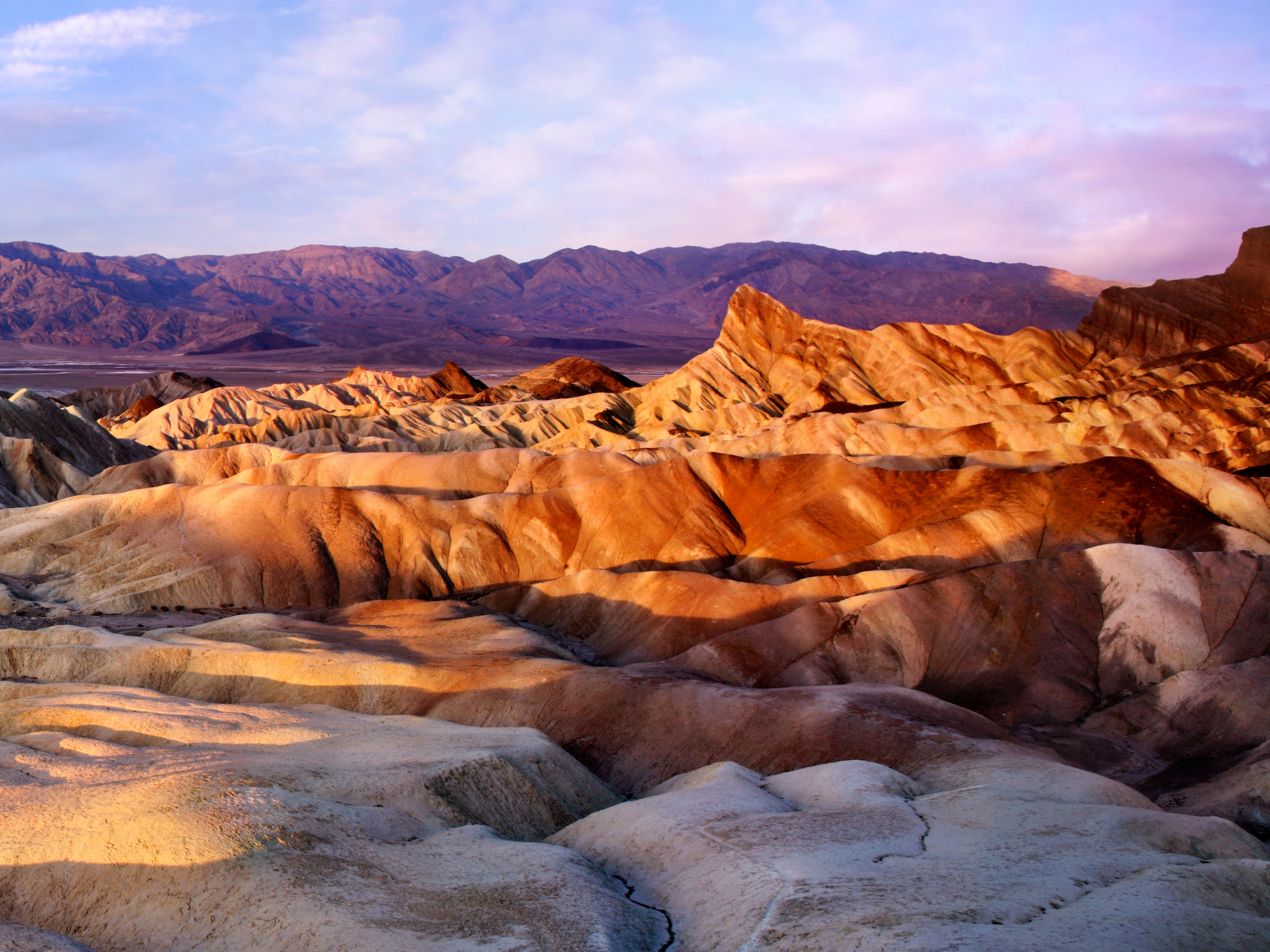 Gorgeous view of the sun setting on rock formations during the best time to visit Death Valley National Park