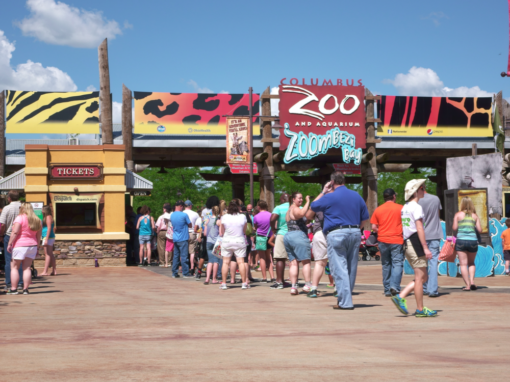 People queuing for tickets at Columbus Zoo and Aquarium, one of the best things to do in Ohio, during a bright sunny day