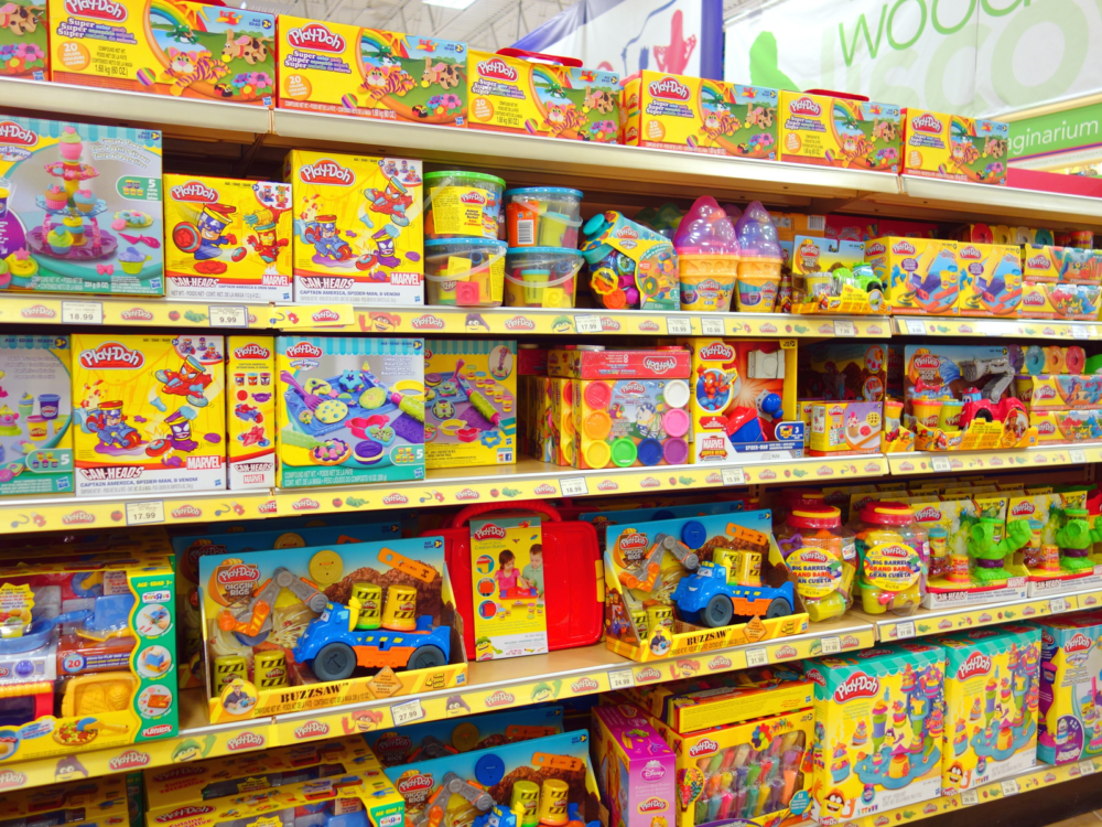 Various kids toy in yellow boxes displayed in a shelf at one of the best toy stores in America, Josh’s Toys & Games in Manchester