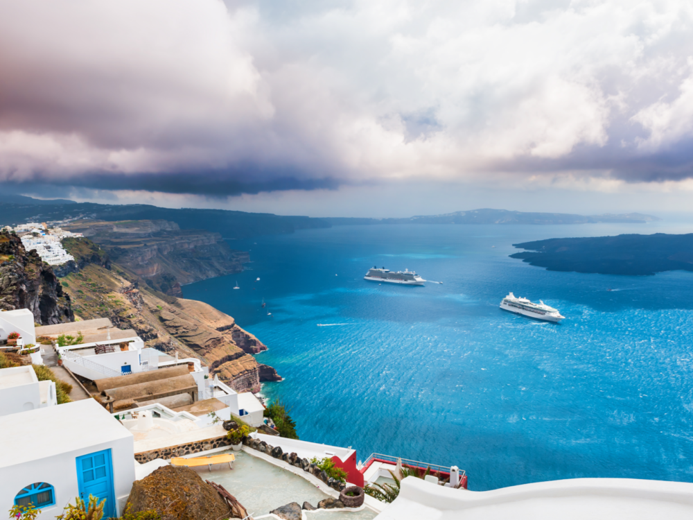 Santorini island pictured during the worst time to visit with rain and dark clouds overhead