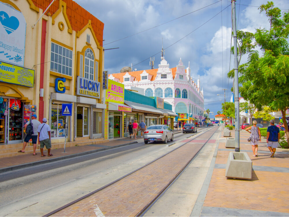 Neat street view of Oranjestad and its streets and tracks for a piece titled Is Aruba Safe