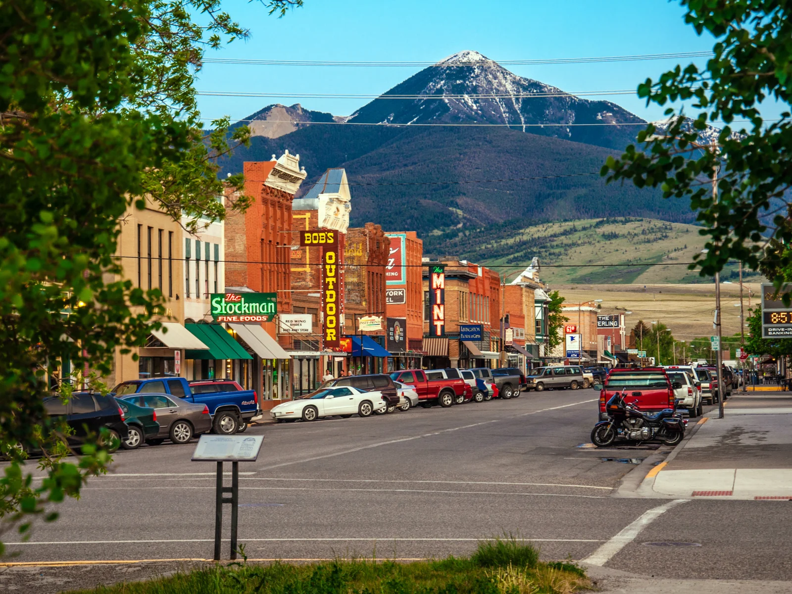 Historic downtown area in Livingston, one of Montana's best places to visit, with a big mountain in the background on a sunny day