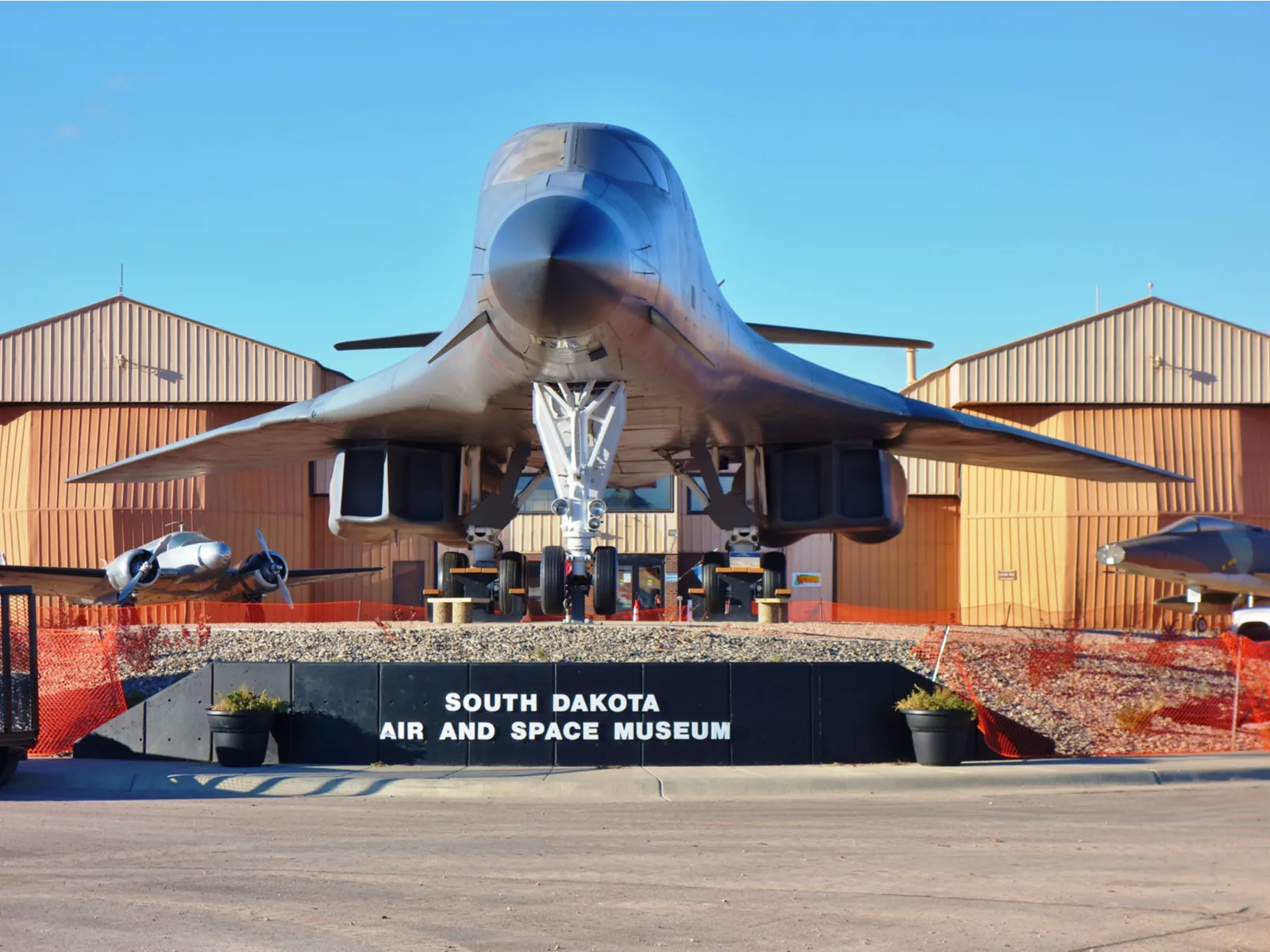 Front of South Dakota Air and Space Museum where an old fighter jet sits on its signage, one of the best South Dakota tourist attractions