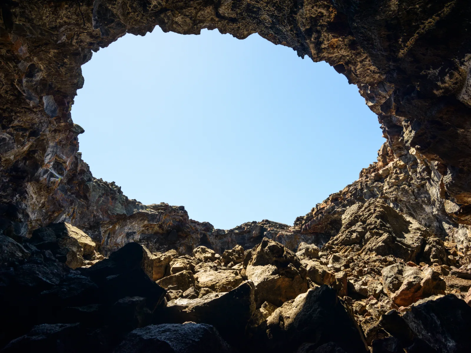 The famous hole on the rocks at Craters of the Moon National Monument and Preserve, one of the best things to see in Idaho