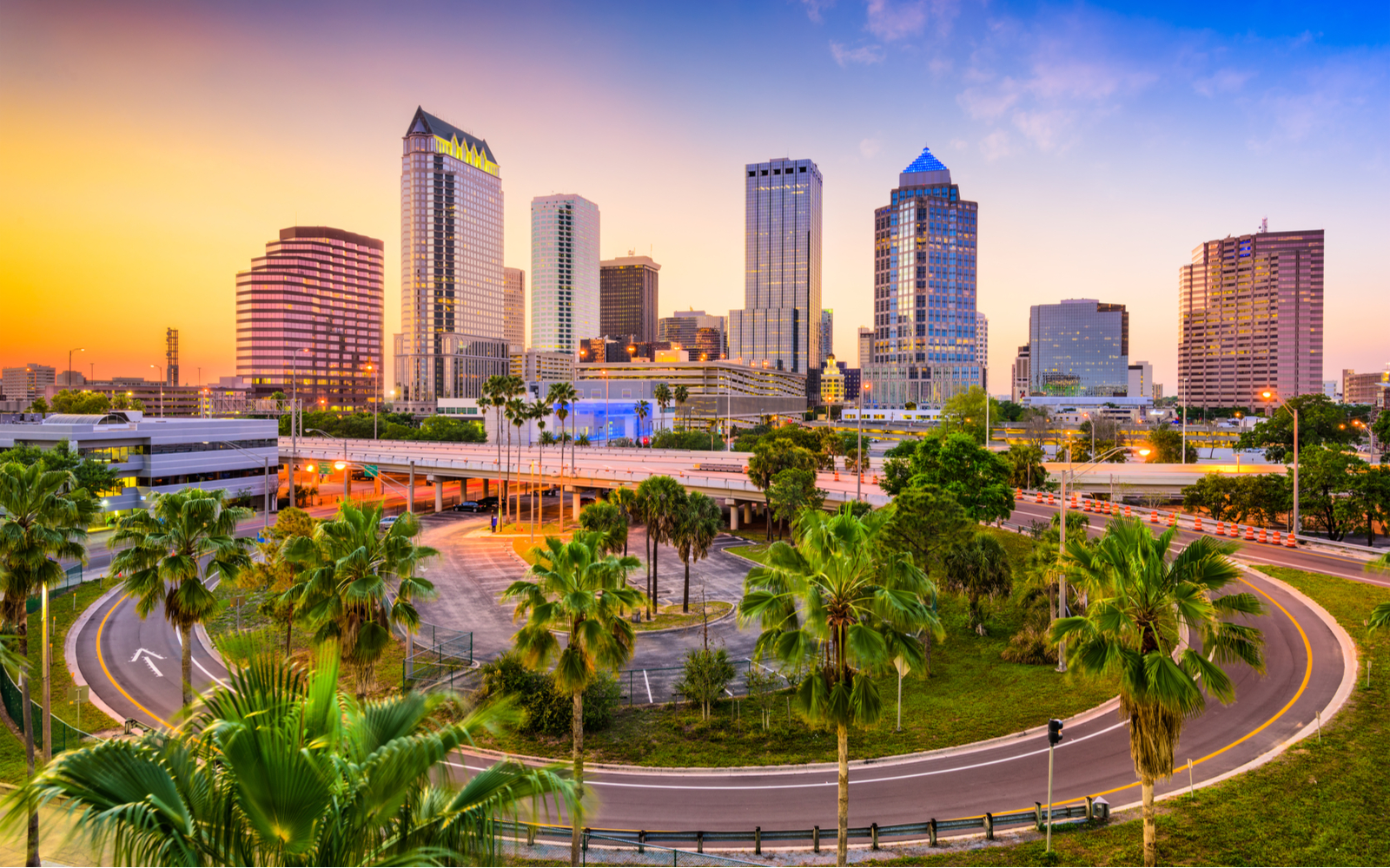 Cover image for a piece titled the Best Things to Do in Tampa featuring a skyline at dusk