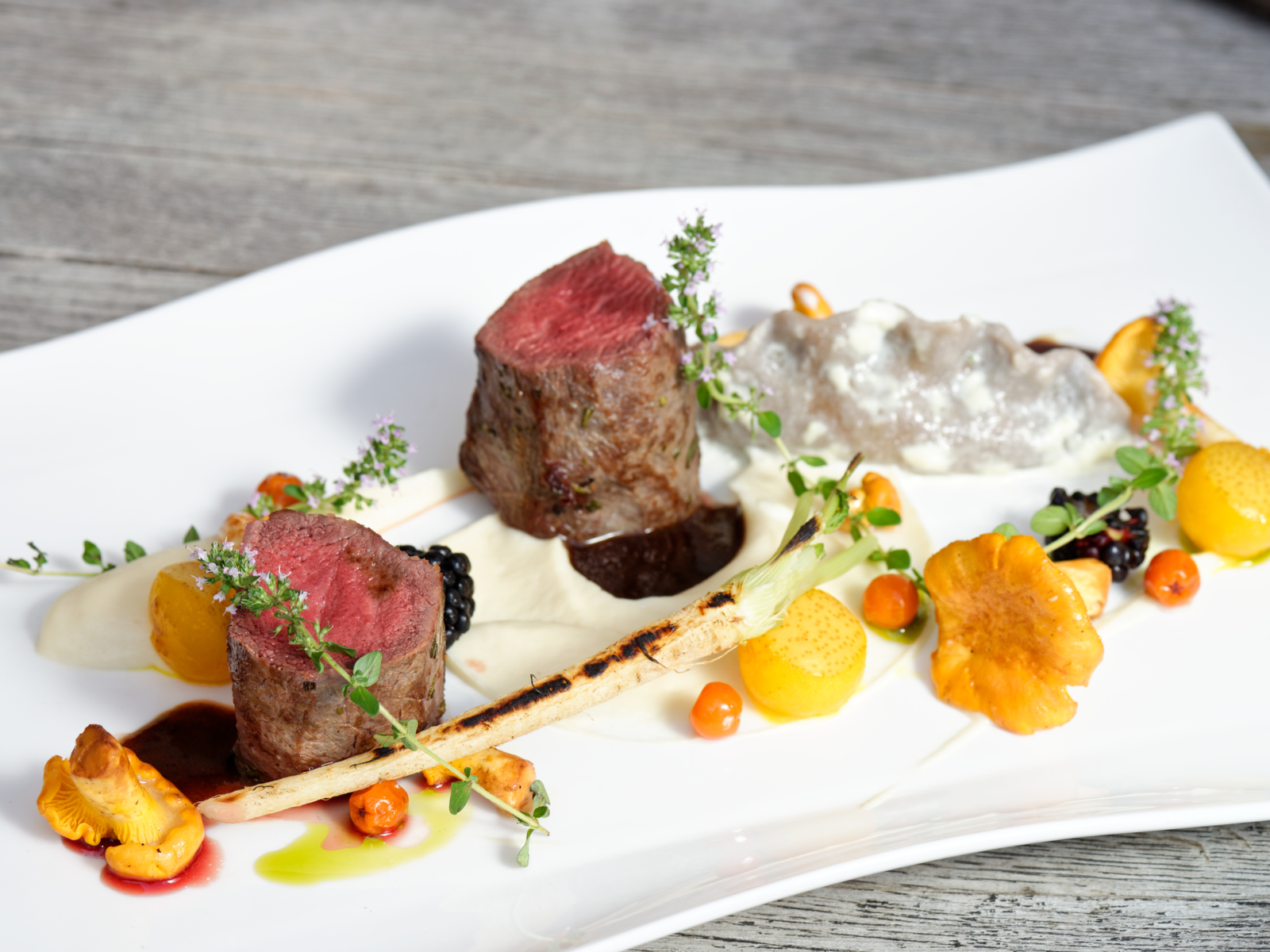 Glazed Lamb Fillet with potatoes and sauce of port served on a white plate at Matarkjallarinn, known as one of the best restaurants in Iceland