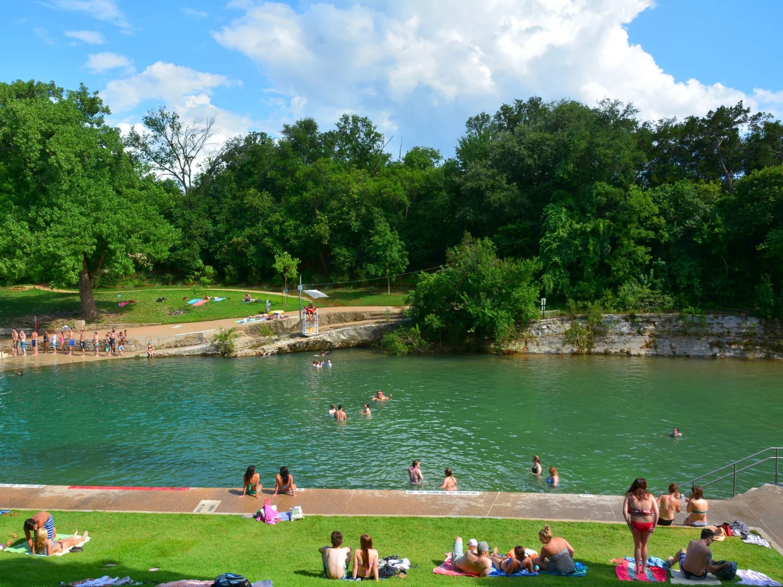 Barton Springs Pool pictured during the worst time to visit Austin, the Summer, featuring extreme heat