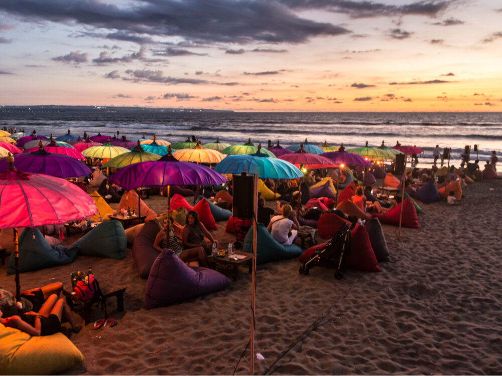 A myriad of youths sitting on inflatable bags during the worst time to visit Bali