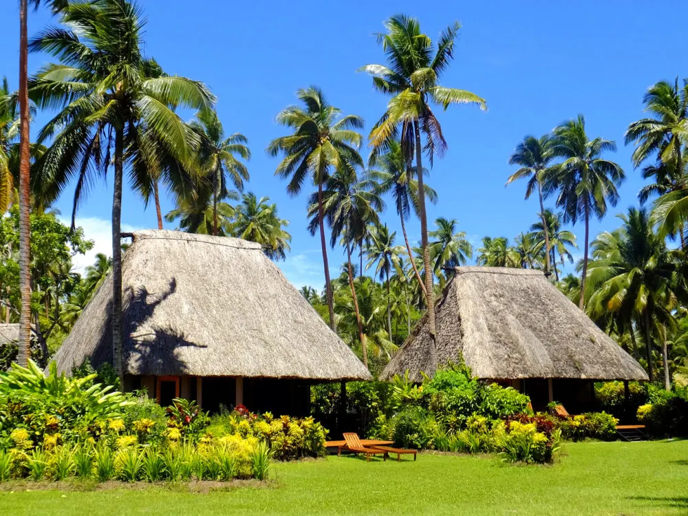 Huts with thatched roofs pictured during the cheapest times to visit Fiji