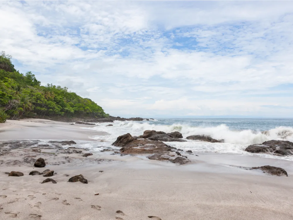 Huge waves crashing to the rocks of Montezuma Beach, one of the best beaches in Costa Rica