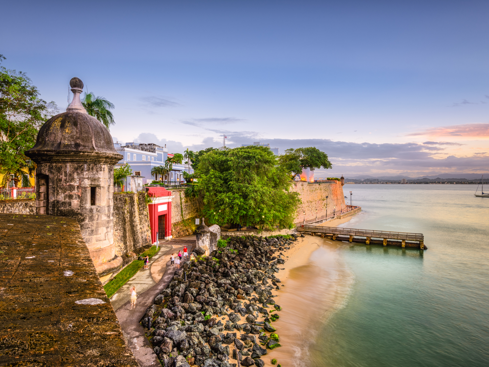 San Juan cliffside fort pictured in the evening for a piece on the best places to visit in the Caribbean