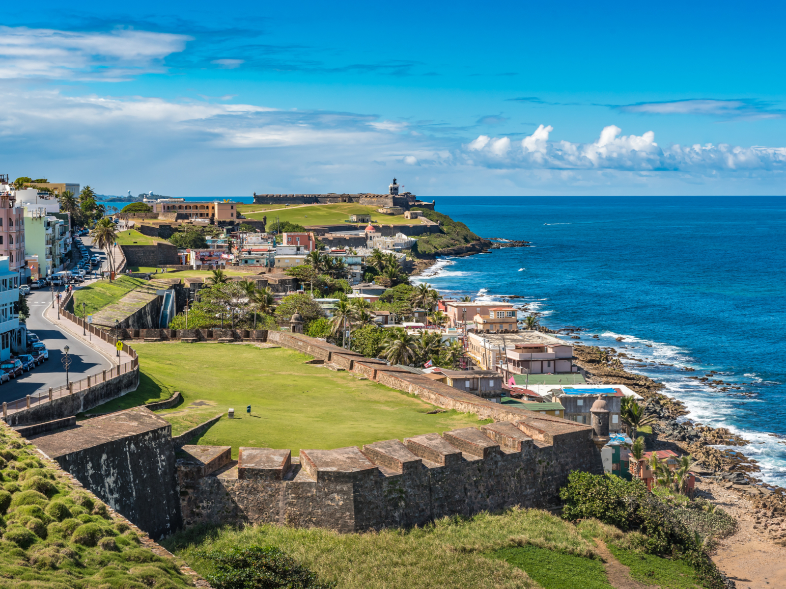 Cool view of the ocean and Castillo de San Cristobal as viewed from a lookout point for a piece on the best hotels in Puerto Rico