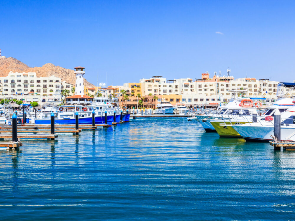 Marina in Cabo pictured during the best time to visit with blue water, warm temperatures, and blue sky