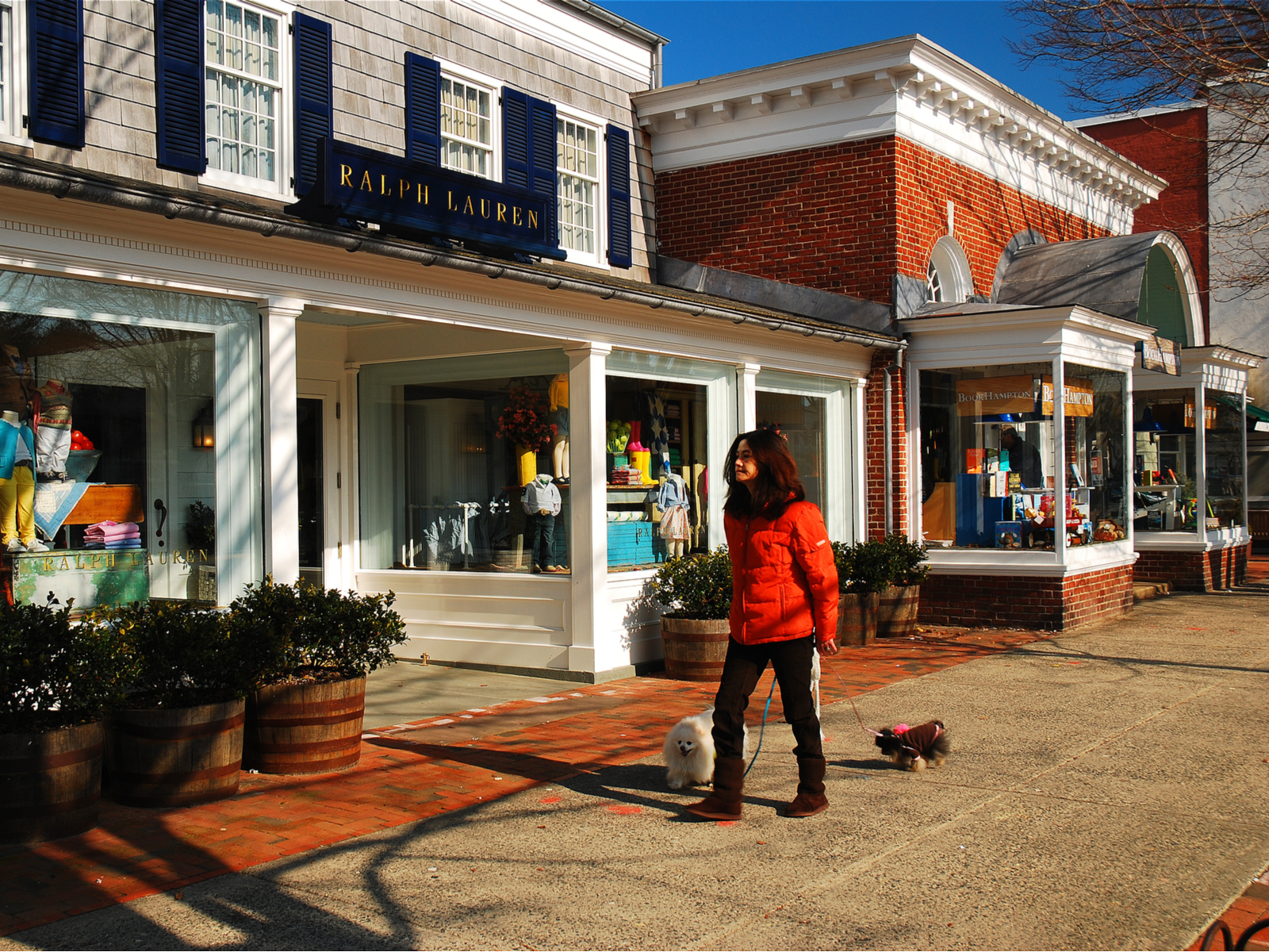 Woman walking outside the market square in East Hampton, a top pick for where to stay in the Hamptons