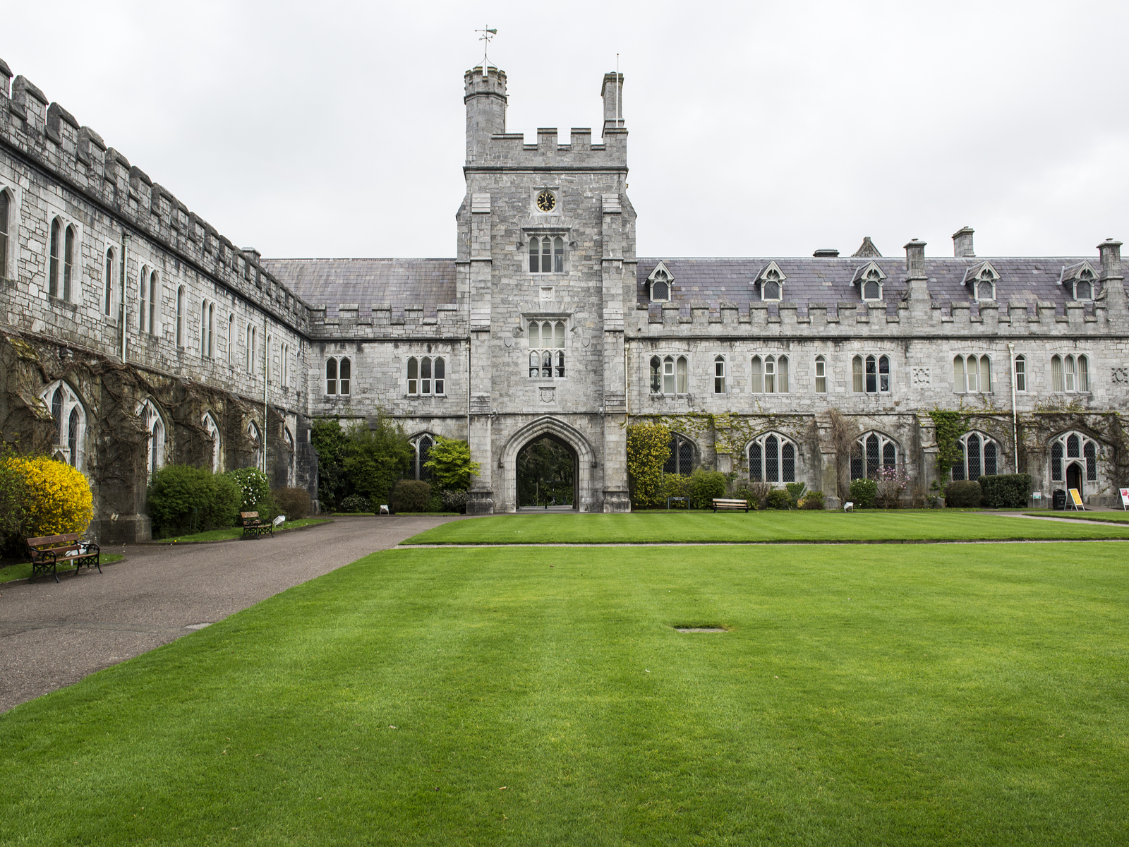well-maintained green lawn at the University College Cork's quadrangle, one of the best universities in Ireland, with its old long hall and clock tower