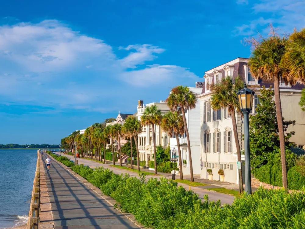 Image of Battery Park during the best time to visit Charleston, SC, with people running on the trail