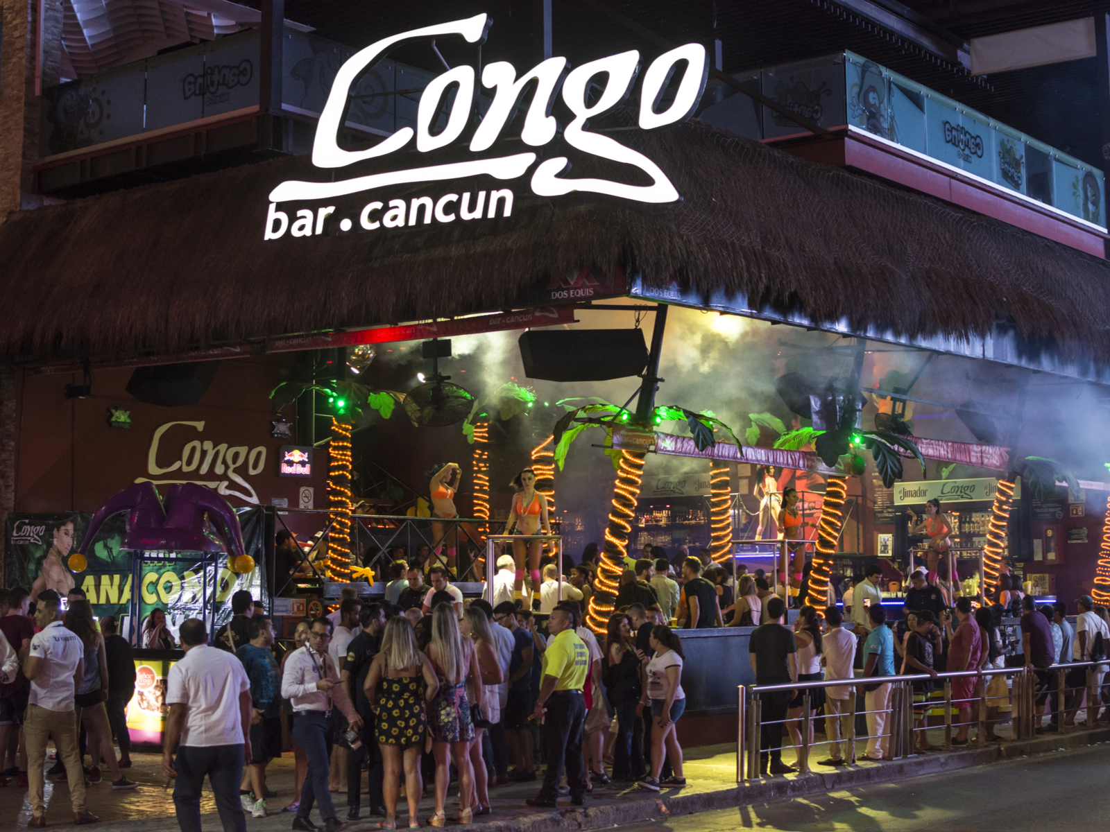 A busy night at Congo Bar Cancun, a place to visit and one of the best clubs in Cancun, where large crowd is partying together with ladies on a platform dancing in their sexy get up