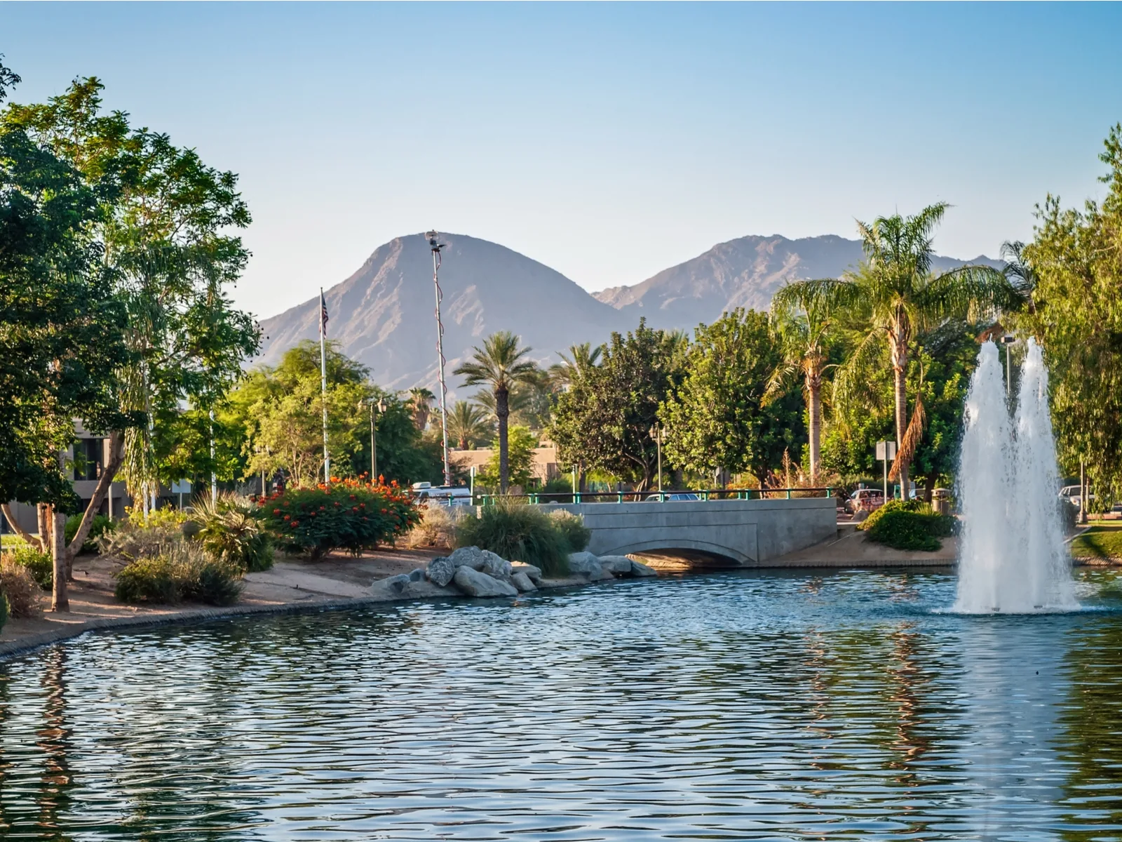 Gorgeous view of a few fountains spouting up from a lake by one of the best hotels in Palm Springs