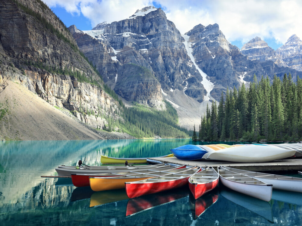 Kayaks on Moraine Lake during the best time to visit Glacier National Park