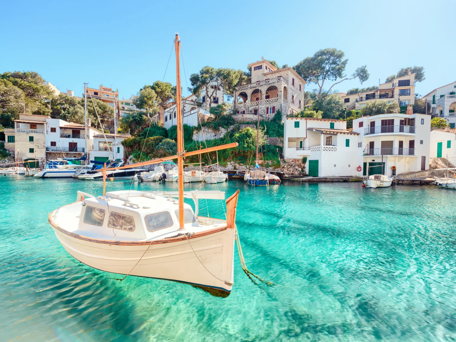 Boat that looks like it's floating at one of the best island vacations destinations, Mallorca Spain