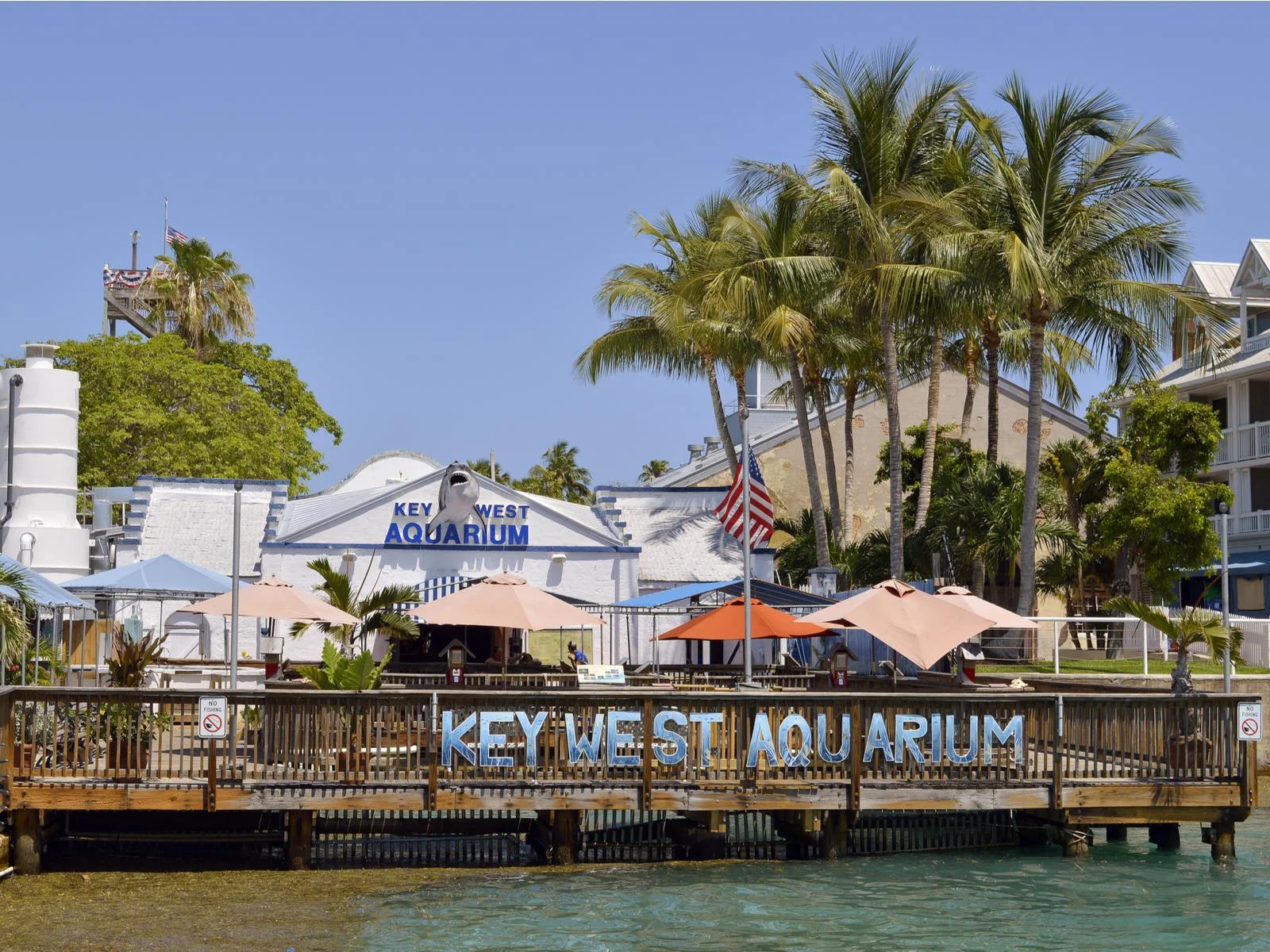 One of the oldest and the best aquariums in Florida, Key West Aquarium with its signage on a boardwalk and shark figure above the entrance