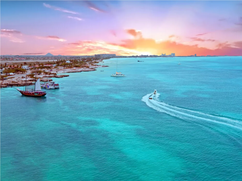 Gorgeous aerial shot of an Aruba beach during sunset during the best time to visit the Caribbean