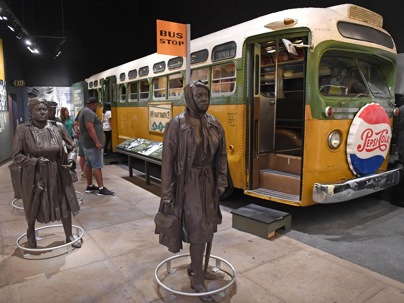 People looking at Rosa Parks exhibit alongside an old bus at the National Civil Rights Museum, one of the best things to do in Tennessee