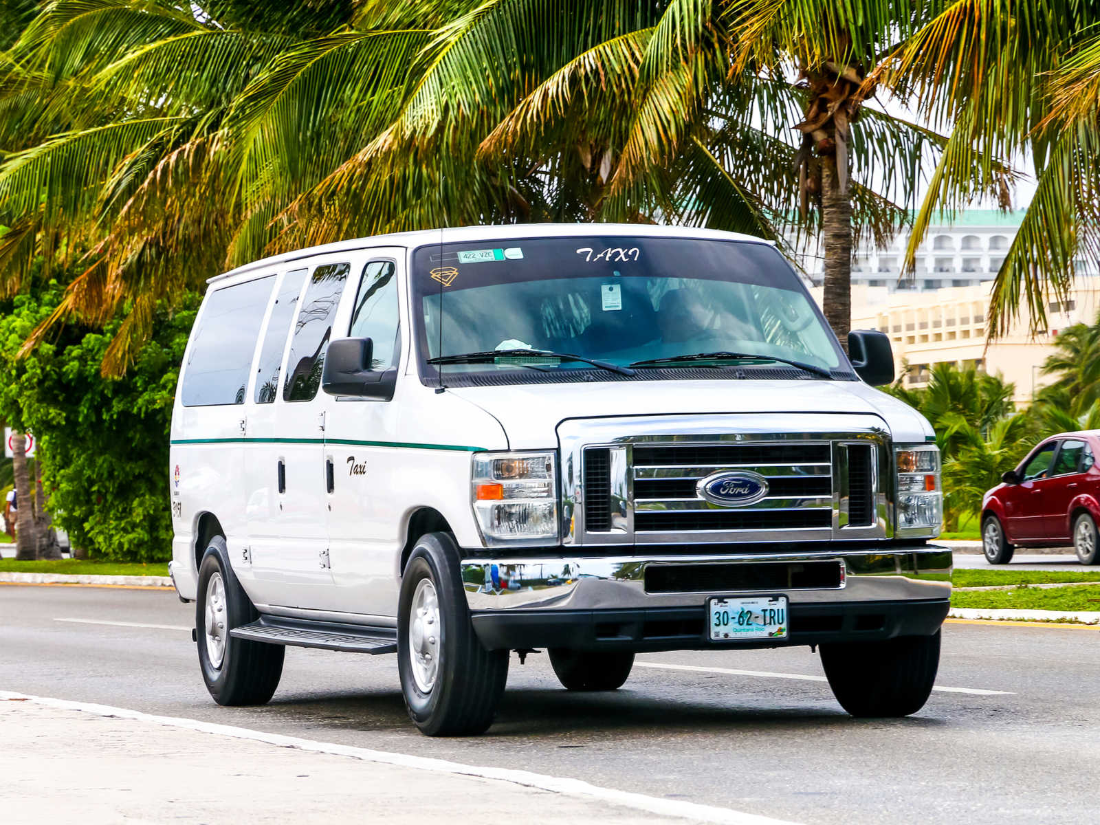 Photo of a white van taxi, one of the ways to get to the best clubs in Cancun