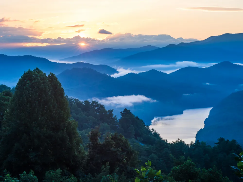 Aerial view of the sun rising over the cold and misty skyline of Great Smoky Mountains National Park, one of the best places to visit in Tennessee