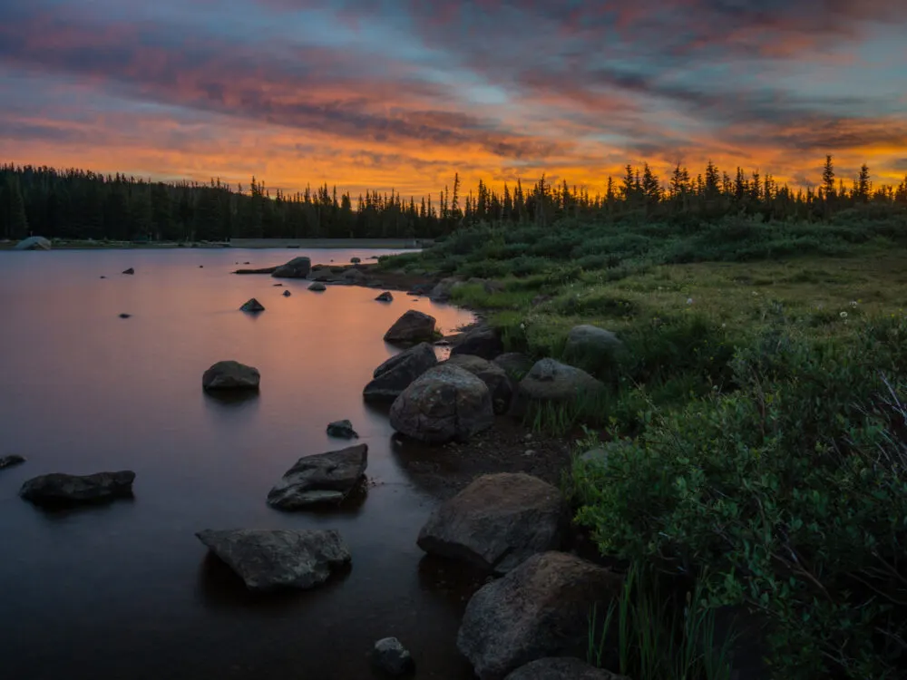 Still waters at Brainard Lake Recreation Area, one of the best hikes near Denver, during a sweet sunset