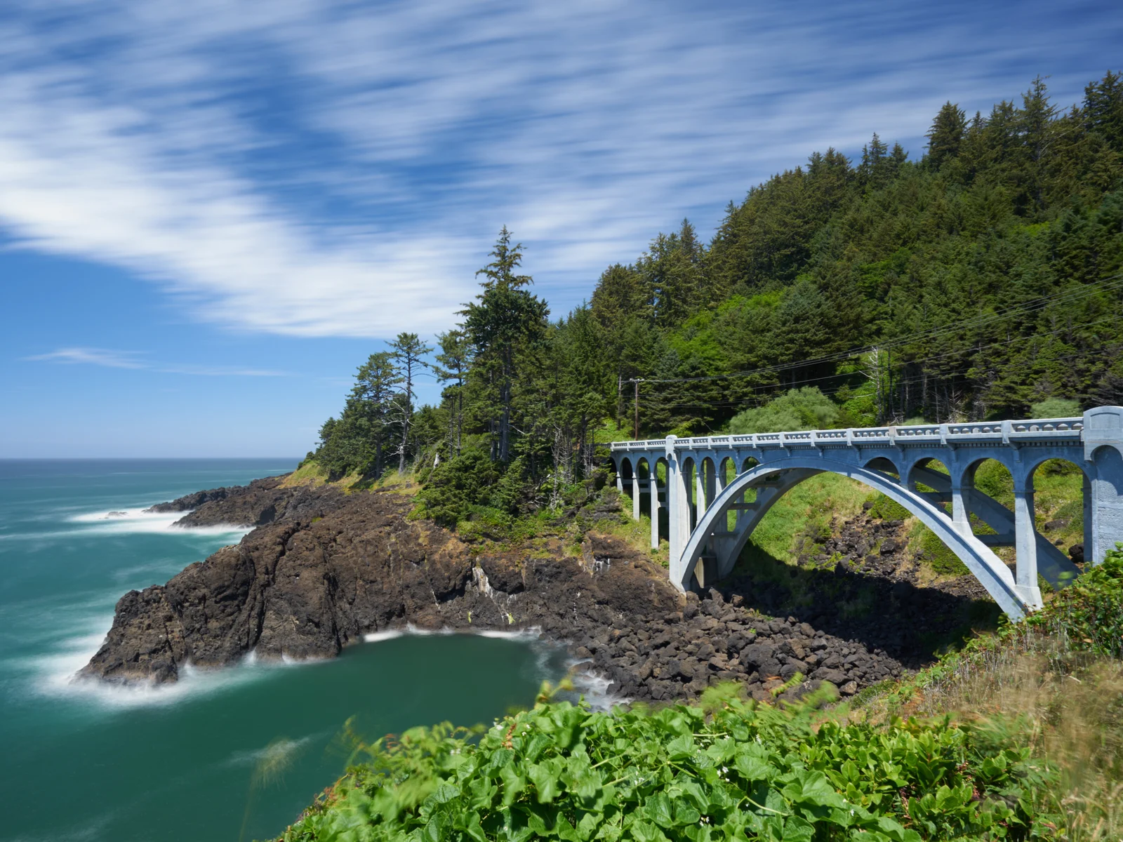 One of the many bridge in one of Oregon's best places to visit, Depoe Bay, pictured along the coastline