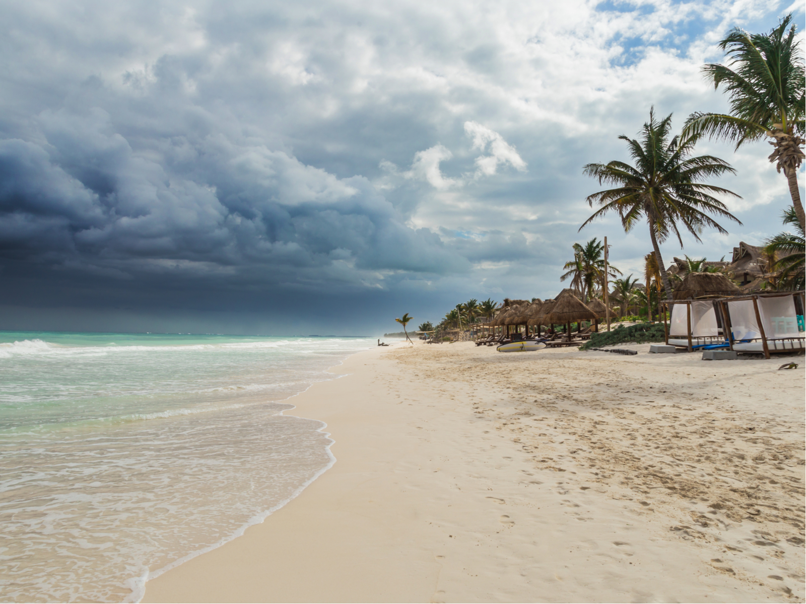Tropical storm pictured during the worst time to visit Cancun with a giant rain cloud over the beach
