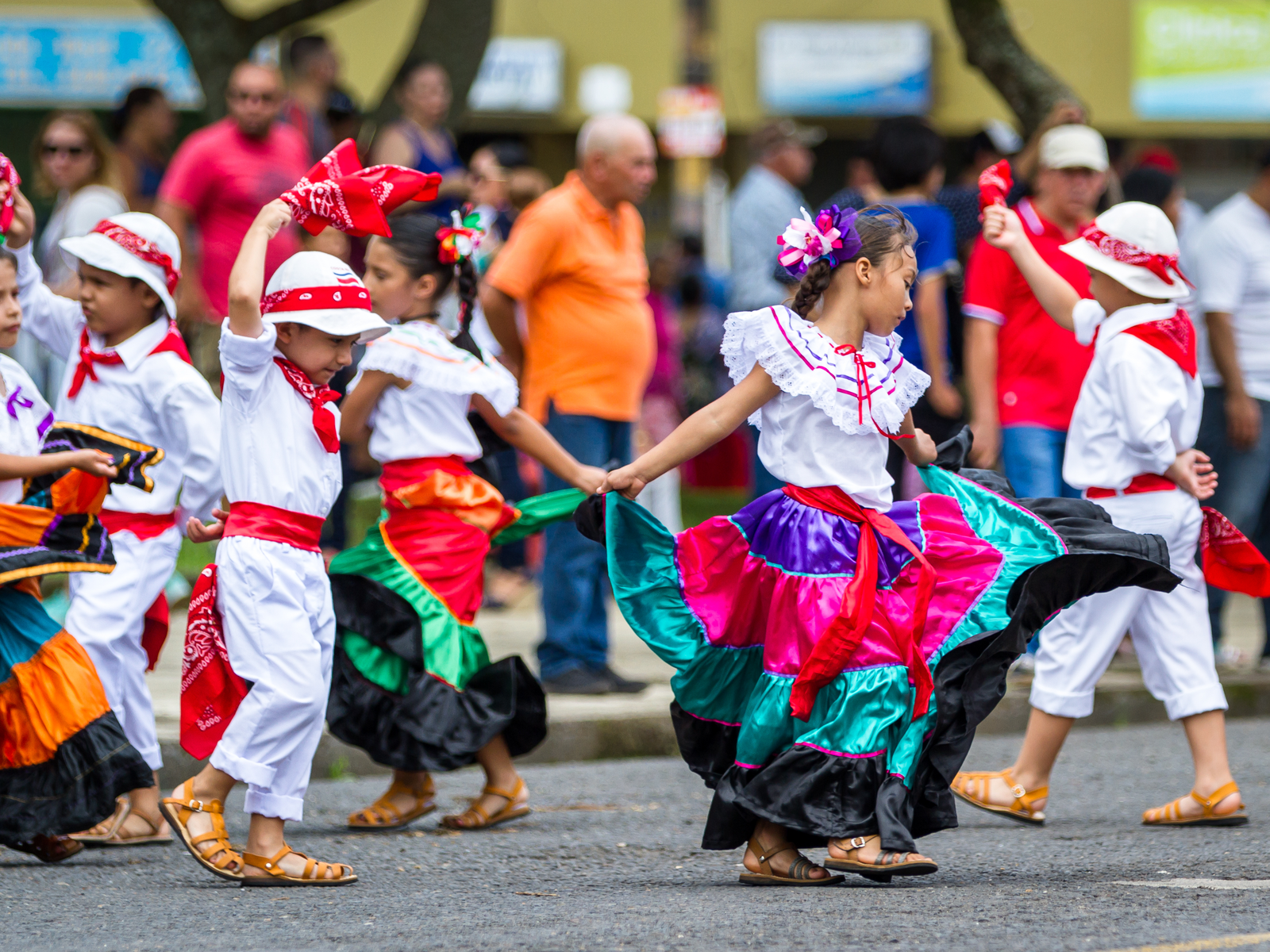 Young children with traditional clothing and dancing in celebration on Independence Day, one of the best things to do in Costa Rica