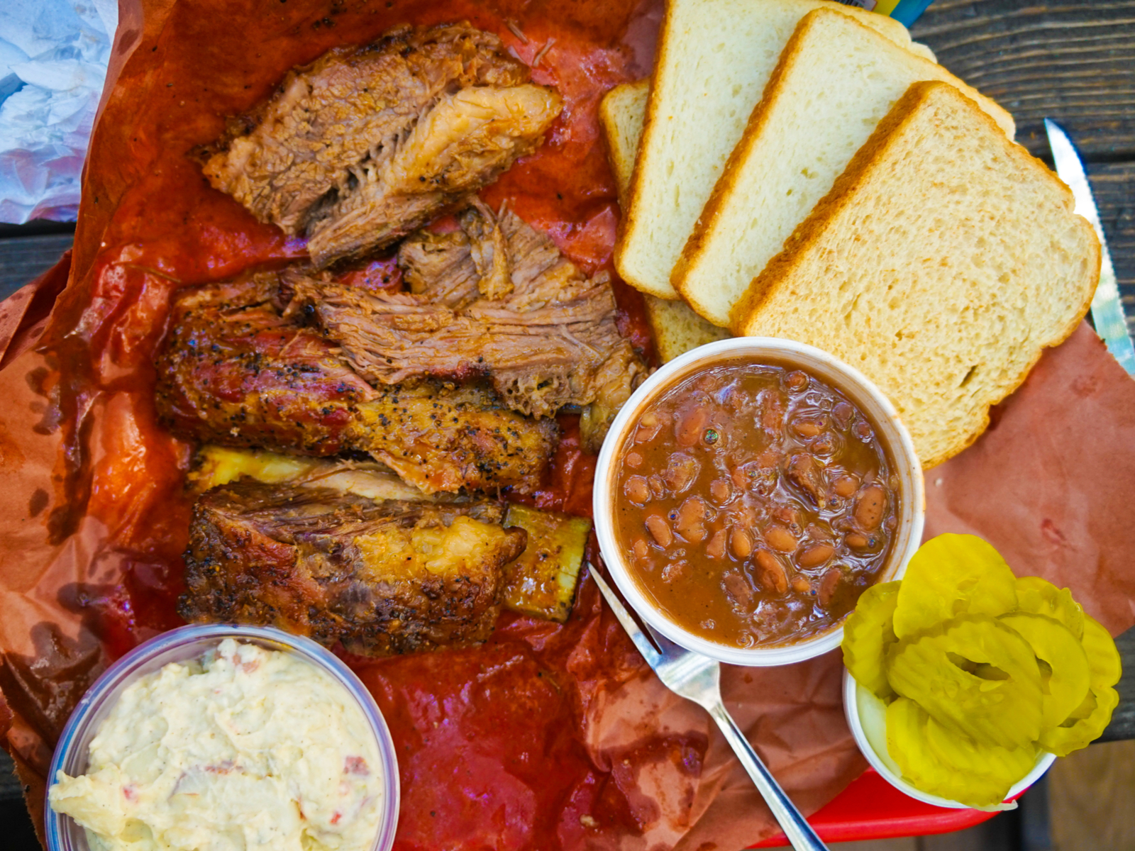 Tasty looking food on a plate filled with bbq and cornbread