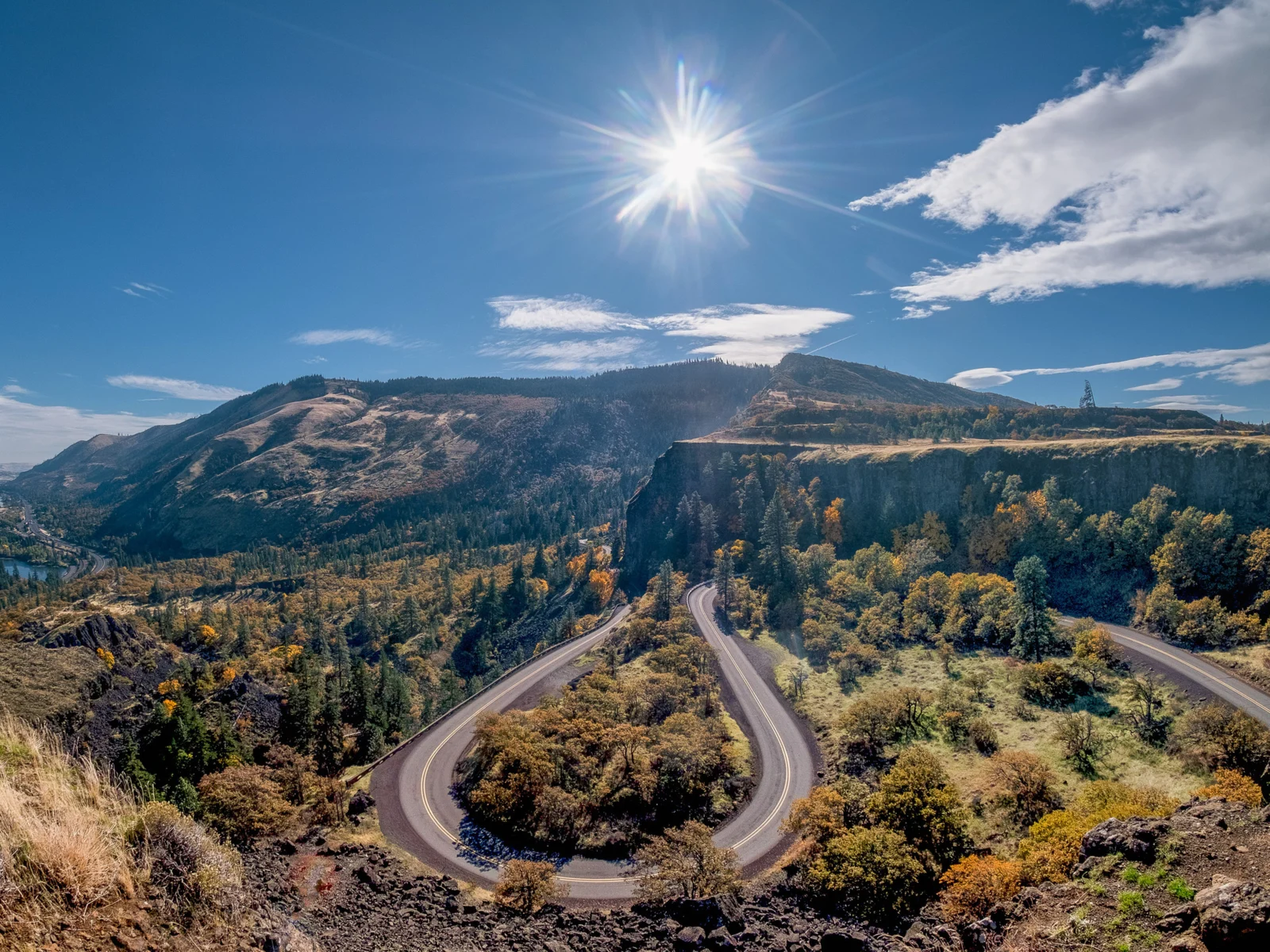 Beautiful day in one of Oregon's best places to visit, the Columbia River Gorge, with a winding road through the treeline