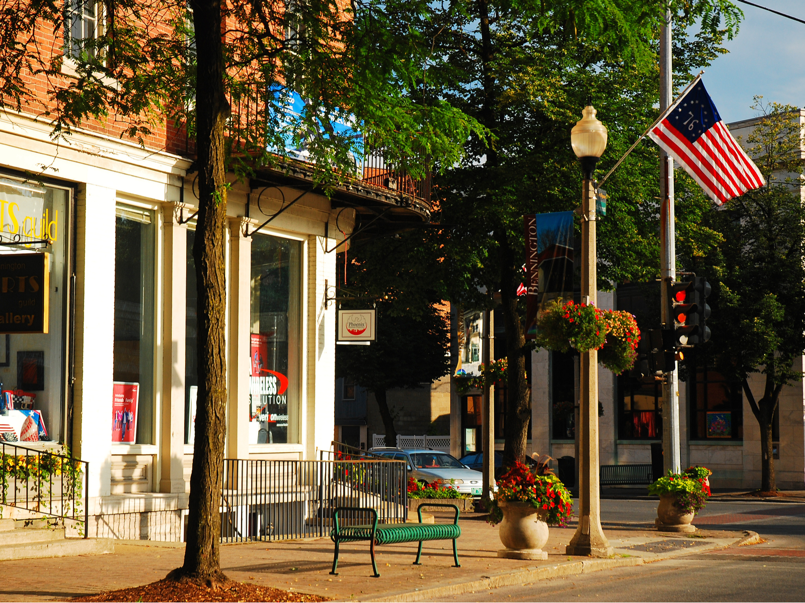 Small corner of town with a flag on the lightpole for a piece on the best places to visit in Vermont