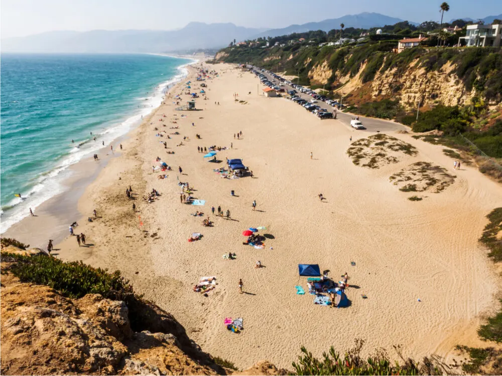 Aerial shot of one of Los Angeles's best attractions, Zuma Beach, with lots of people on it