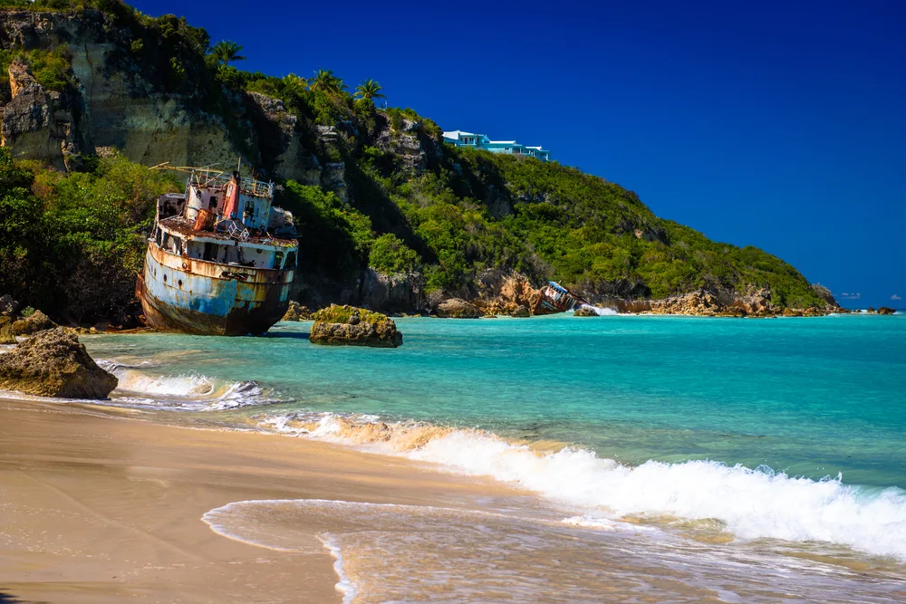 Gorgeous view of a rusty steel shipwreck on the rocks near Sandy Ground Beach in Anguilla, one of the safest islands in the Caribbean